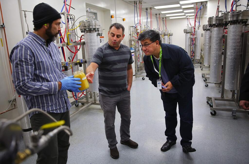 Dennis Hunter show a jar of supercritical CO2 extracted from cannabis